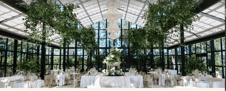 Interior of The Glasshouse at River Oaks set up for a wedding reception